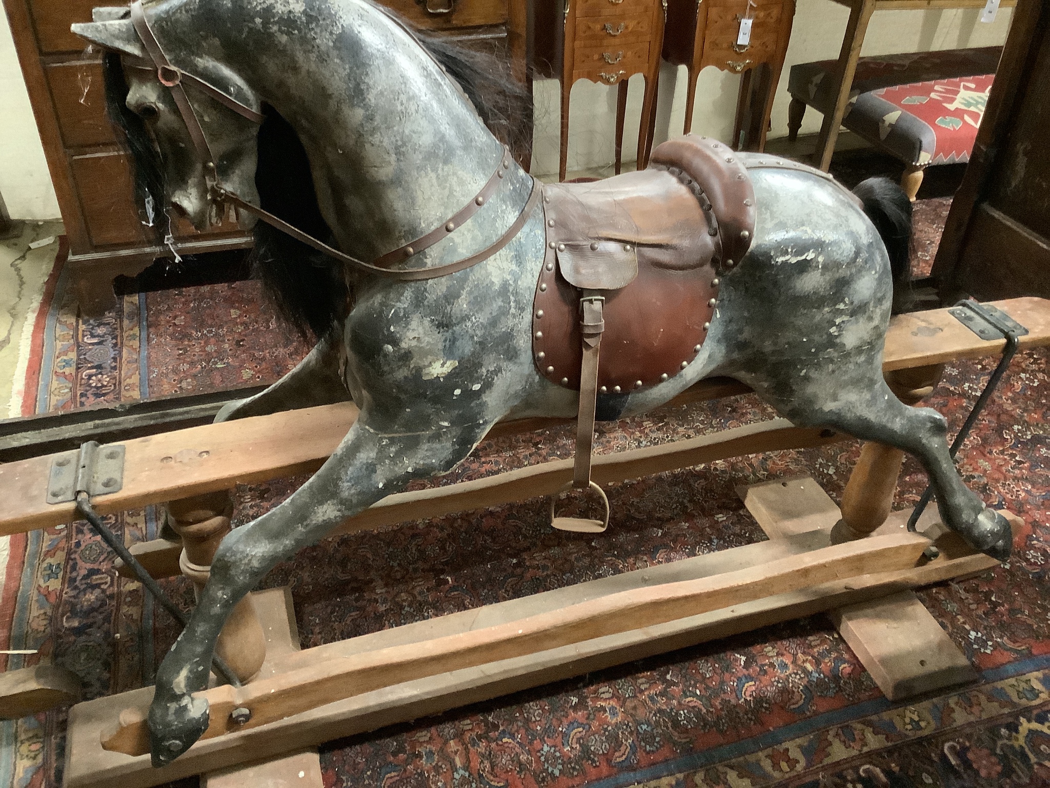 A large Edwardian Ayres type rocking horse on a turned safety frame, length 160cm, height 110cm